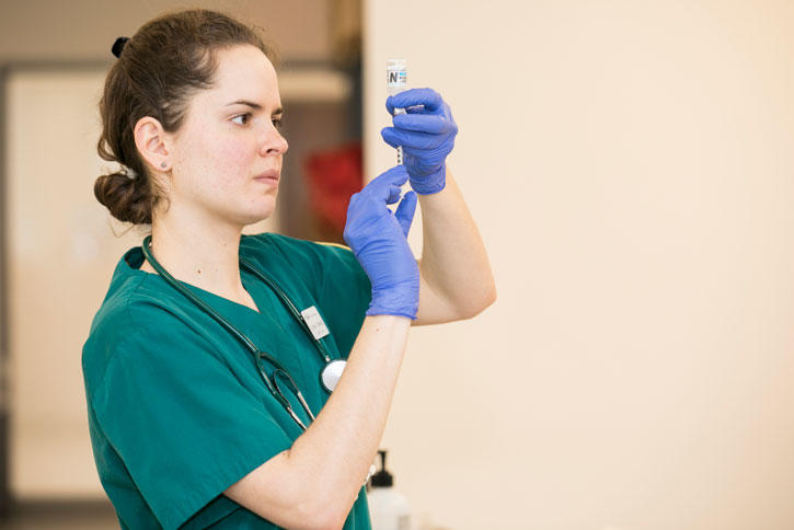 A nurse checks a syringe in Mason's Nursing Program in Peterson Hall on the Fairfax Campus